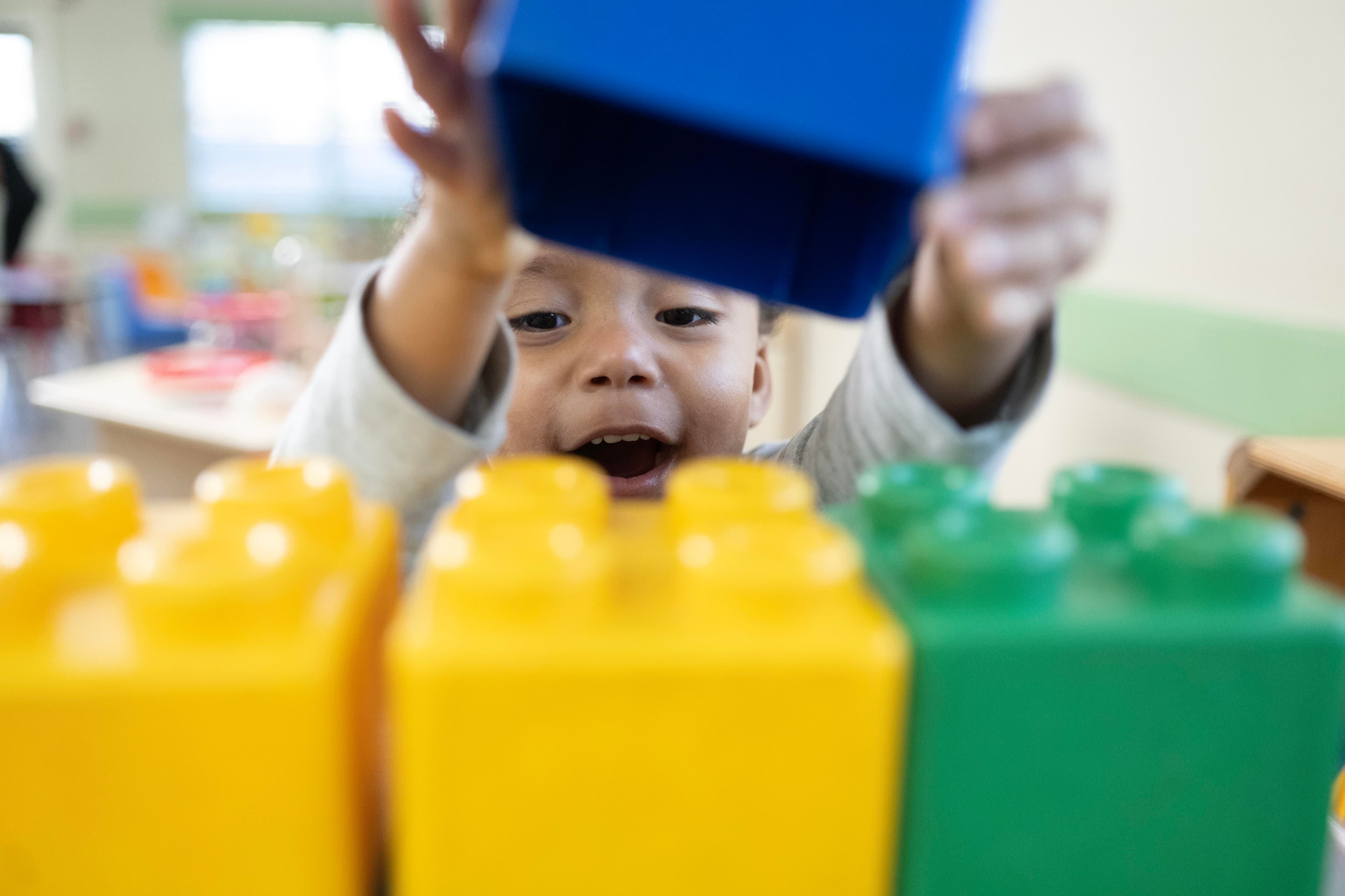 A boy playing with giant lego blocks